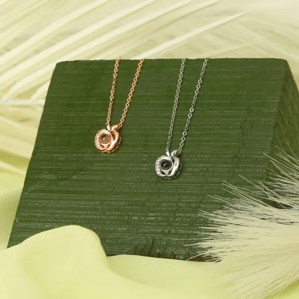 Collection of apple photo necklaces in silver and rose gold, blending elegance with personal keepsakes