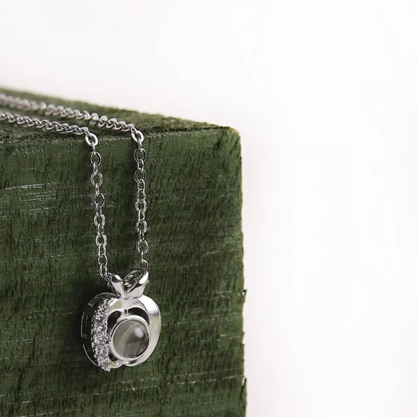 Silver apple photo necklace, designed for a personal keepsake with hidden memory