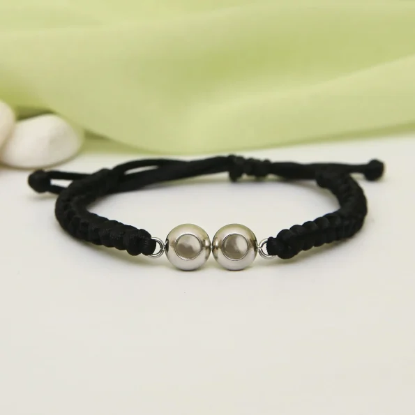 Double pendant braided bracelet in black, perfect for holding precious memories
