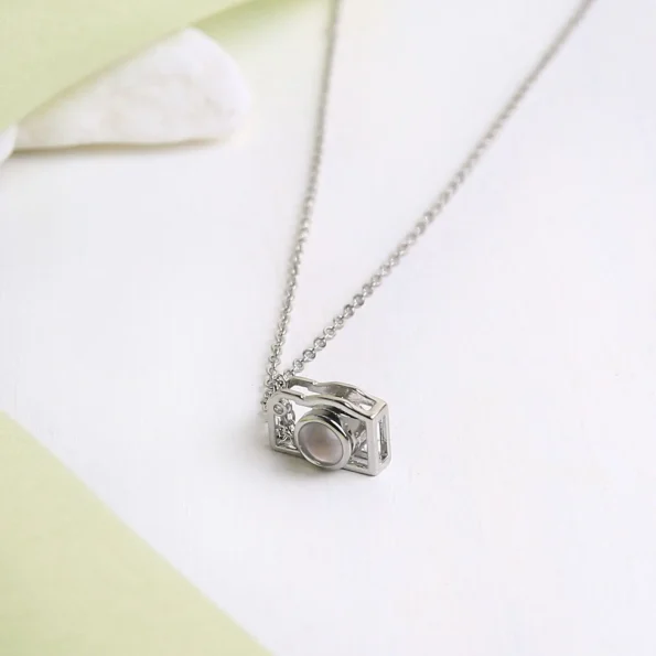 Unique silver camera necklace with hidden photo, crafted for personal memories