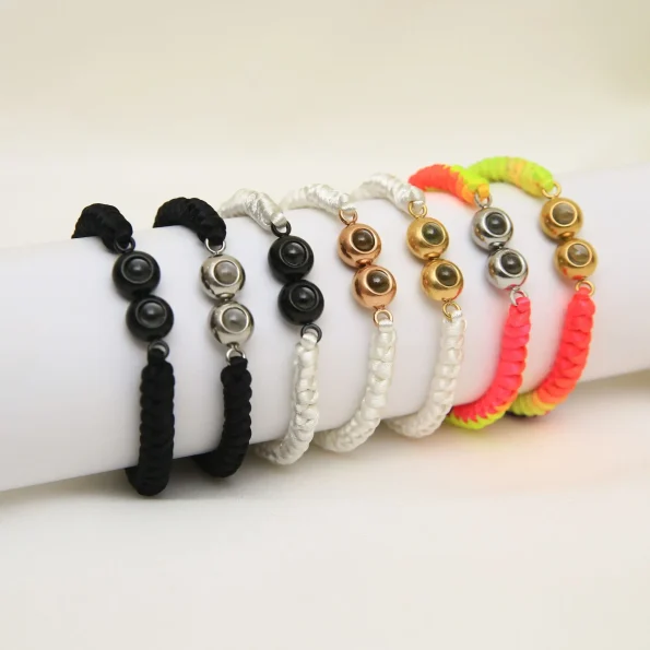Group of double pendant braided bracelets in black, white, and multi-color options