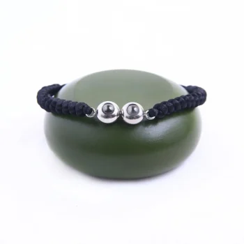 Black braided photo bracelet with double pendant, adding a personalized touch to your look