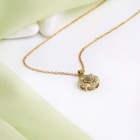 Gold projection flower necklace with four heart charms, a sweet and elegant piece