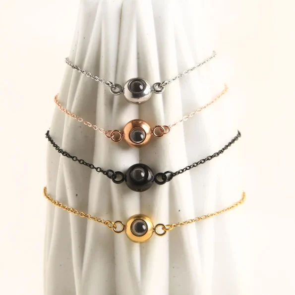 Collection of slim chain photo bracelets in silver, rose gold, and black, a meaningful accessory
