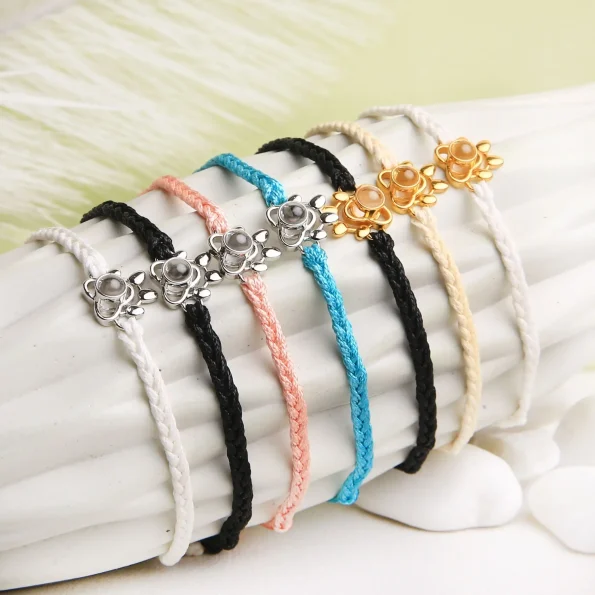 Group picture of pet paw photo bracelets in black, pink, white, turquoise, and beige