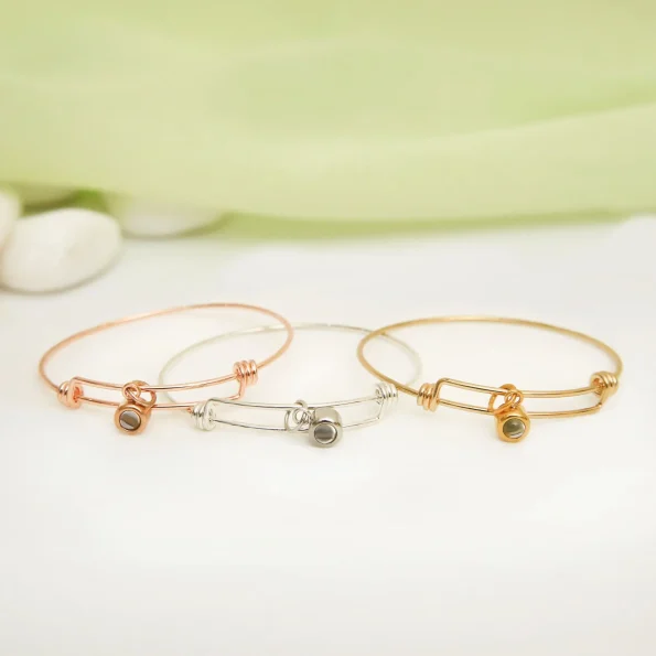 Group of knot bangles in silver, gold, and rose gold
