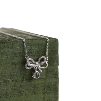 Elegant silver knot photo necklace with personalized charm, perfect for memorable memories
