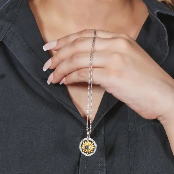 Model holding classic sunflower necklace – beautiful jewelry piece perfect for any occasion