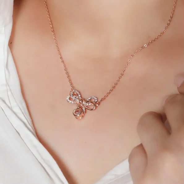 Model wearing rose gold knot necklace, adding a modern, personal touch