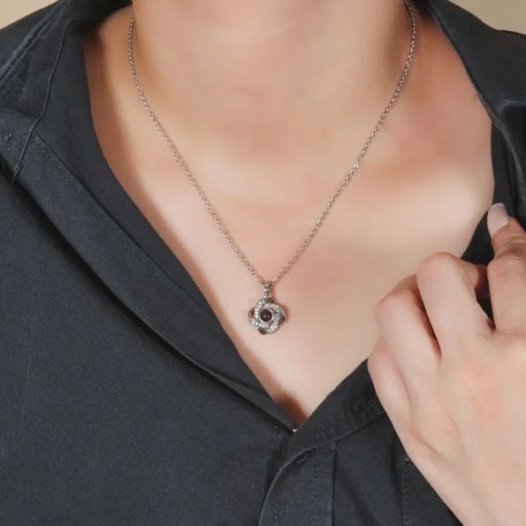 Model showcasing silver four-leaf necklace, an elegant accessory for personal memories