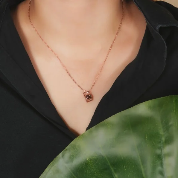Model wearing rose gold camera locket, a charming photo keepsake necklace