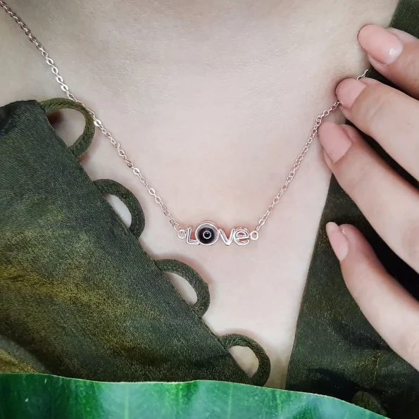 Girl showcasing rose gold love necklace for a chic touch