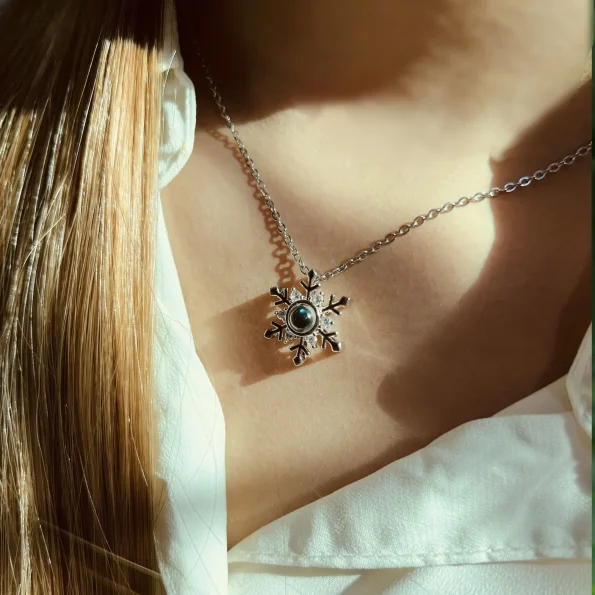 Model showcasing silver snowflake necklace, blending elegance with personal style