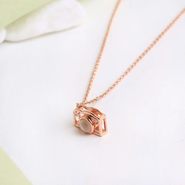 Rose gold camera pendant, capturing sentimental moments