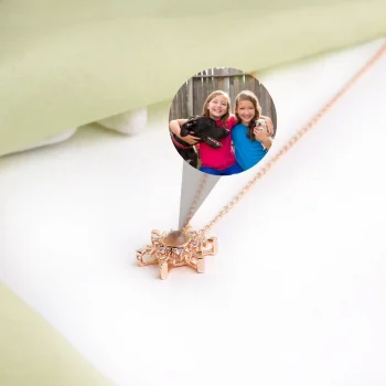 Rose gold snowflake projection locket with hidden photo, perfect for adding warmth