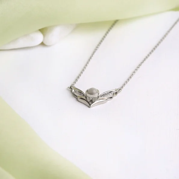 Silver angel wings necklace, capturing elegance and personal sentiment