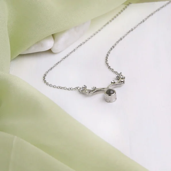 Elegant silver antler necklace with projection, perfect for a memorable charm