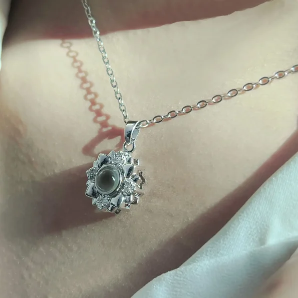 Lifestyle shot of silver flower heart necklace, capturing timeless elegance
