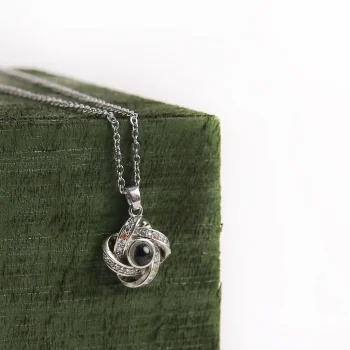 Silver four-leaf charm necklace with a hidden photo keepsake, capturing cherished memories