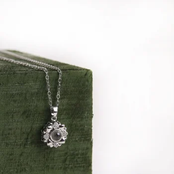Elegant silver flower necklace with four delicate heart charms, perfect for daily wear