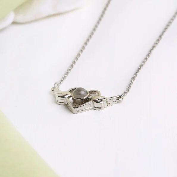 Elegant silver wings heart necklace, perfect for a personalized photo keepsake