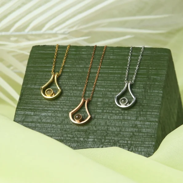 Group of U-shaped necklaces in gold, silver, and rose gold finishes