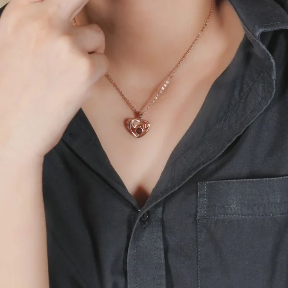 Woman wearing rose gold heart deer necklace, a personalized photo locket