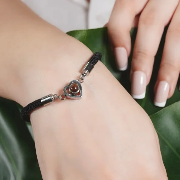 Woman showcasing silver heartbound photo bracelet, a stylish touch for any occasion
