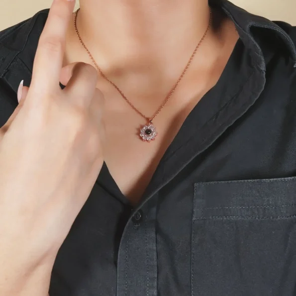 Woman wearing rose gold flower charm necklace, an elegant and modern look