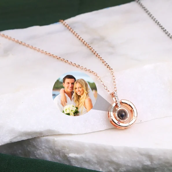 Unique rose gold roman projection necklace with the pendant displayed at an angle, highlighting its intricate craftsmanship and modern elegance.