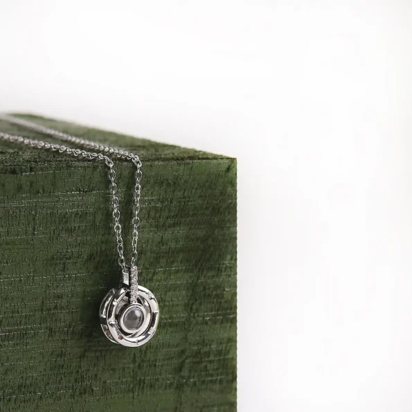 Elegant silver roman projection necklace with a pendant angled slightly to showcase its sleek and minimalist design, perfect for gifting someone special.