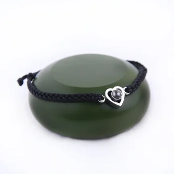 Close-up of black rope heart bracelet, showcasing its elegant and intricate design.