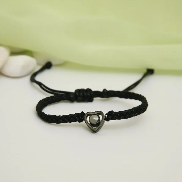 Black rope heart bracelet with a hidden photo, a stylish and sentimental keepsake.