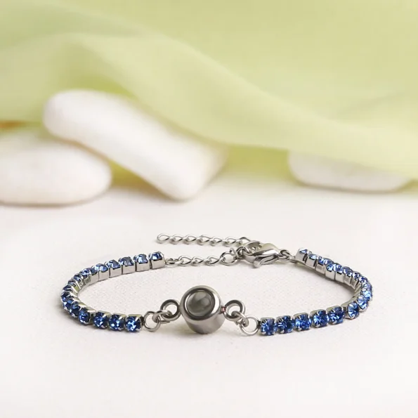 Blue tennis charm bracelet with hidden projection, a meaningful gift to cherish memories of loved ones.