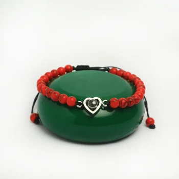Close-up of red frosted stone heart bracelet, showcasing its bold elegance and hidden photo feature.