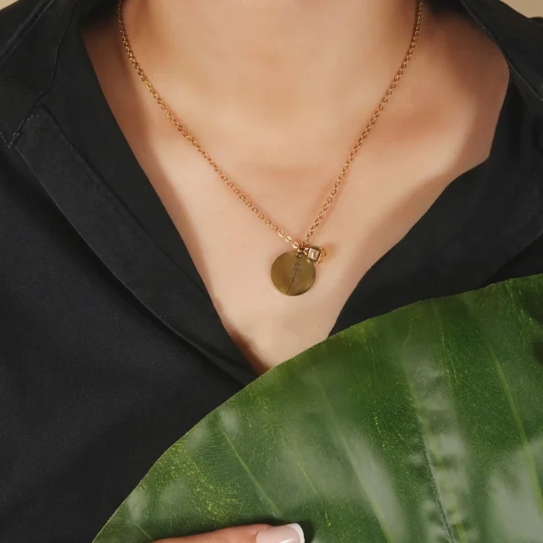 Model wearing gold birthflower photo necklace, showcasing its elegant and sentimental charm.