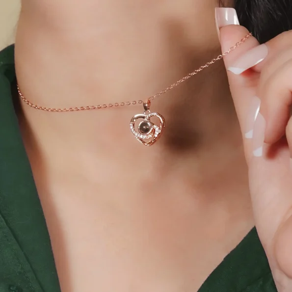 Girl wearing rose gold heart charm photo necklace, a beautiful way to carry a cherished memory.