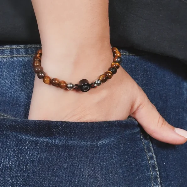 Girl wearing a tiger eye frosted photo bracelet, adding a natural and meaningful accent to her look.