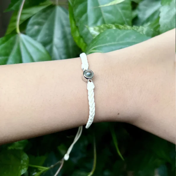 Girl wearing a white rope projection bracelet, adding a touch of delicate charm to her look.