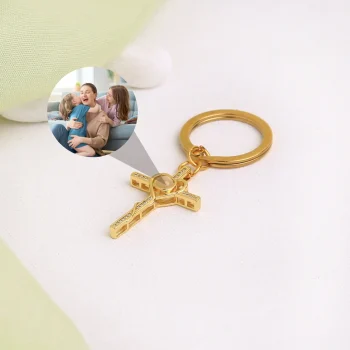 Gold heart and cross keychain featuring a hidden projection, a timeless keepsake to hold precious memories.