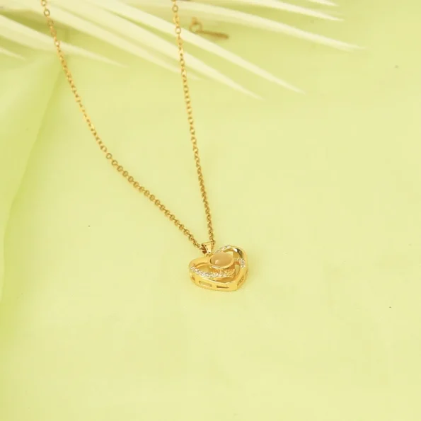 Gold heart charm photo necklace featuring a hidden photo, a meaningful piece for treasured moments.