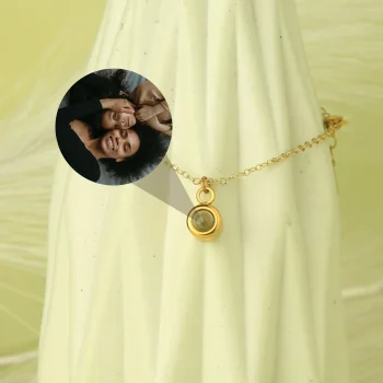 Elegant gold charm bracelet with a glowing pendant, a timeless keepsake for cherished memories.