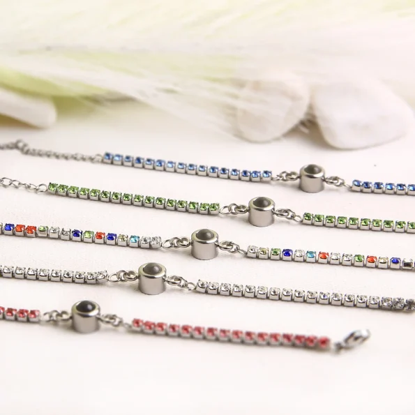 Group shot of tennis charm bracelets in white, green, blue, pink, and multicolor, ideal for special occasions and treasured memories.