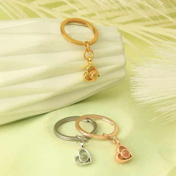 Group of heart photo keychains in gold, silver, and rose gold, symbolizing love and memories.