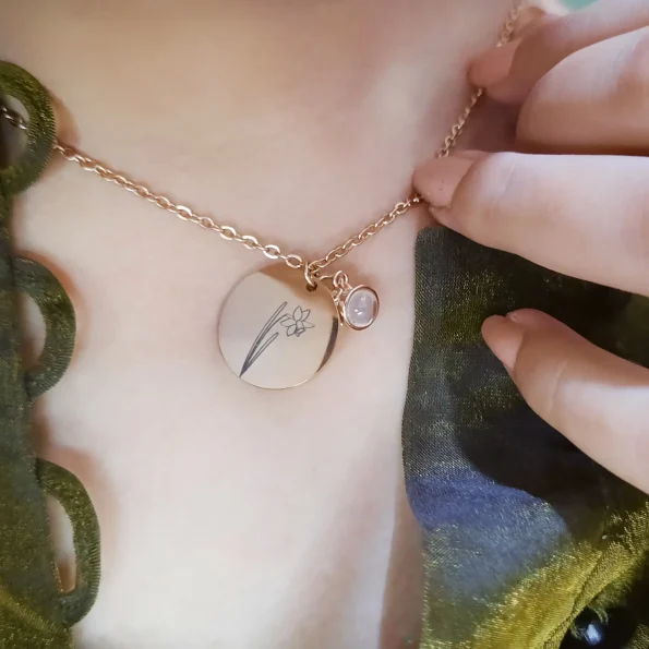 Girl wearing a gold birthflower photo necklace, adding a graceful and personal touch to her style.