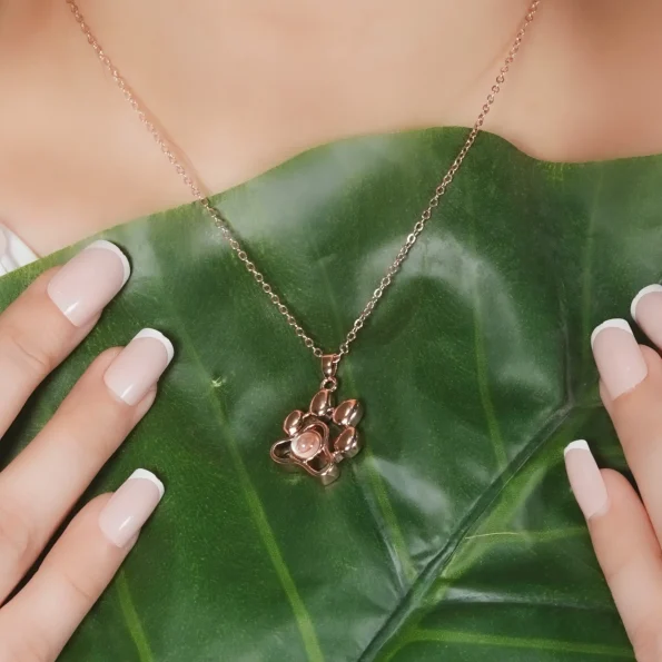 Model showcasing a rose gold pet paw necklace with a hidden photo, a symbol of love and loyalty.