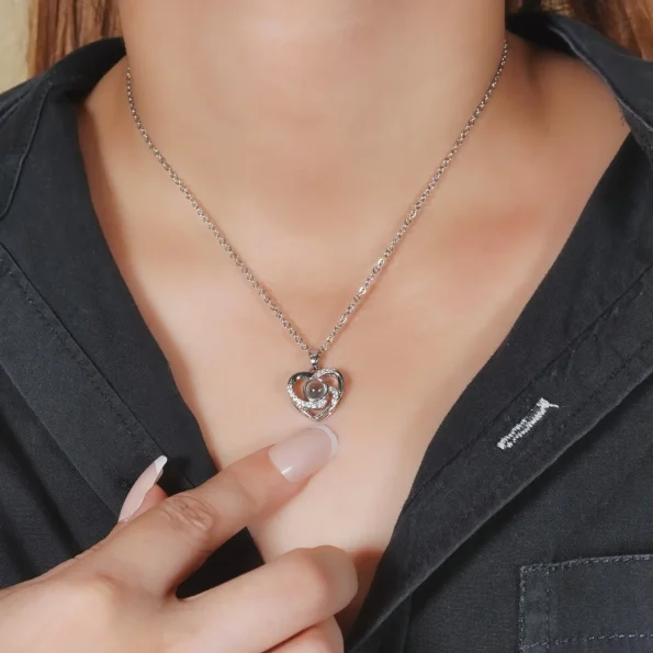 Model wearing silver heart charm photo necklace, a stylish yet sentimental piece for everyday wear.