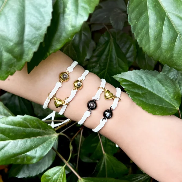 Model wearing white photo bracelets, exuding modern elegance with a personal touch.