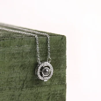Silver photo necklace with a hidden memory inside.