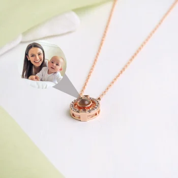 Rose gold projection pendant holding a precious picture.